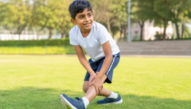 Child running outdoors showing healthy, strong knees during active play